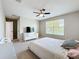Well-lit bedroom with a ceiling fan, neutral walls, carpet and large window for ample natural light at 10658 Bannan St, Orlando, FL 32832