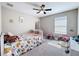 Bright bedroom with ceiling fan, plush carpet, and a charming floral bedspread at 10658 Bannan St, Orlando, FL 32832