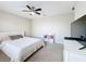 Comfortable bedroom with ceiling fan, neutral tones, carpet, and a wall-mounted television at 10658 Bannan St, Orlando, FL 32832