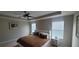 This bedroom features a tray ceiling with fan, two windows, and carpeted floors at 10658 Bannan St, Orlando, FL 32832