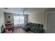 Comfortable bonus room with large sectional sofa, window and ample storage for toys at 10658 Bannan St, Orlando, FL 32832