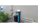 Water solution system with pipe details and a large black trash can beside the house at 10658 Bannan St, Orlando, FL 32832