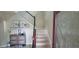 Inviting foyer with staircase, decorated console table, and an elegant front door at 10658 Bannan St, Orlando, FL 32832