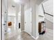 Entry hallway with tile flooring, view of the living room, white walls and staircase at 10658 Bannan St, Orlando, FL 32832