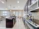 Kitchen with dark cabinets, stainless steel appliances, granite countertops, and tiled backsplash at 10658 Bannan St, Orlando, FL 32832