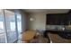 Kitchen nook with wooden table, chairs, and backyard access, all illuminated by modern chandelier at 10658 Bannan St, Orlando, FL 32832