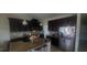 Spacious kitchen with dark cabinets, stainless steel appliances, granite countertops, and center island at 10658 Bannan St, Orlando, FL 32832