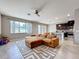 Living room with brown sectional couch, large windows, neutral walls, and adjacent kitchen view at 10658 Bannan St, Orlando, FL 32832