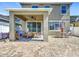 This covered patio features brick flooring, a ceiling fan, outdoor seating, and ample space for entertaining and relaxation at 10658 Bannan St, Orlando, FL 32832