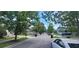 Quiet residential street with lush green trees and well-manicured lawns creating a peaceful neighborhood at 10658 Bannan St, Orlando, FL 32832
