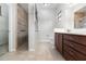 Bathroom with tiled shower, vanity with drawers, and toilet at 11255 Se 170Th Pl, Summerfield, FL 34491
