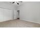 Bedroom features neutral carpet, ceiling fan, and a double door closet for storage at 11255 Se 170Th Pl, Summerfield, FL 34491