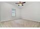 Empty bedroom with neutral carpet, white walls, baseboard trim, and a window for natural light at 11255 Se 170Th Pl, Summerfield, FL 34491