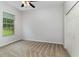 Bedroom featuring neutral carpet, natural light from window, ceiling fan, and a double door closet at 11255 Se 170Th Pl, Summerfield, FL 34491