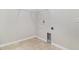 Tiled laundry room with white walls and hookups for washer and dryer and wire shelving above at 11255 Se 170Th Pl, Summerfield, FL 34491