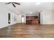 Inviting open-concept space featuring sleek flooring, a ceiling fan, and easy access to the kitchen at 11255 Se 170Th Pl, Summerfield, FL 34491