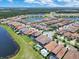 Aerial view of a neighborhood showcasing backyard pools, landscaping, and lake views at 13139 Stanthorne Ave, Orlando, FL 32832
