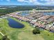 Scenic aerial shot featuring a residential area and a lush green golf course with a scenic pond at 13139 Stanthorne Ave, Orlando, FL 32832