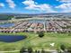 An elevated view shows a residential community featuring lush golf course with a scenic pond at 13139 Stanthorne Ave, Orlando, FL 32832
