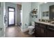 Bathroom with granite counters, dark wood cabinets, and a glass-enclosed shower for a luxurious experience at 13139 Stanthorne Ave, Orlando, FL 32832