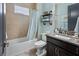 Stylish bathroom with granite vanity, blue walls, and a tub and shower combination offers a calming retreat at 13139 Stanthorne Ave, Orlando, FL 32832