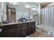 Bathroom with dual sinks, granite counters, modern fixtures, and decorative touches at 13139 Stanthorne Ave, Orlando, FL 32832