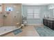 Bright bathroom showcasing a glass-enclosed shower, sleek tile, and stylish ladder shelf at 13139 Stanthorne Ave, Orlando, FL 32832