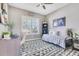 Cozy bedroom featuring a comfortable daybed, stylish rug, and plenty of natural light from the window at 13139 Stanthorne Ave, Orlando, FL 32832