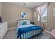 Cozy bedroom with black metal bed frame and lots of light from the window at 13139 Stanthorne Ave, Orlando, FL 32832