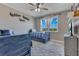 Bedroom with twin beds, blue and white striped bedding, a ceiling fan, and a large window for natural light at 13139 Stanthorne Ave, Orlando, FL 32832