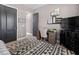 Stylish bedroom with decorative wall art, a dark wood dresser, and a comfy desk area at 13139 Stanthorne Ave, Orlando, FL 32832
