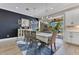 Elegant dining room with stylish lighting, a dark accent wall, and sliding glass doors to the outdoor living area at 13139 Stanthorne Ave, Orlando, FL 32832