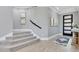 Inviting entryway features wood-look tile flooring and a carpeted staircase leading to the upper level of the home at 13139 Stanthorne Ave, Orlando, FL 32832