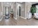 Elegant foyer with wood-look tile, tray ceiling, decorative mirror and table, plus a stylish front door at 13139 Stanthorne Ave, Orlando, FL 32832