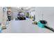 Spacious garage with epoxy flooring, a golf cart, and ample storage space for vehicles and equipment at 13139 Stanthorne Ave, Orlando, FL 32832