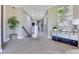 Spacious upstairs hallway with lots of natural light, carpeted floors, and a storage cabinet with dark accents at 13139 Stanthorne Ave, Orlando, FL 32832