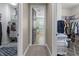 Hallway between walk-in closets, featuring neutral tones and tile floors at 13139 Stanthorne Ave, Orlando, FL 32832