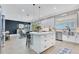 Contemporary kitchen with a central island, stainless steel appliances, and white cabinets and countertops at 13139 Stanthorne Ave, Orlando, FL 32832