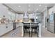 Well-lit kitchen featuring a central island with seating, white cabinetry, and modern appliances at 13139 Stanthorne Ave, Orlando, FL 32832