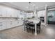 Bright kitchen with white cabinets, a center island with seating, and stainless steel appliances at 13139 Stanthorne Ave, Orlando, FL 32832