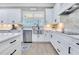 Bright kitchen features white cabinets, stainless steel appliances, and modern fixtures at 13139 Stanthorne Ave, Orlando, FL 32832