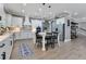 Spacious white kitchen with a center island, stainless steel appliances, and modern pendant lighting at 13139 Stanthorne Ave, Orlando, FL 32832