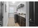 Functional laundry room with a front load washer and dryer and granite countertops at 13139 Stanthorne Ave, Orlando, FL 32832