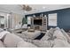 Inviting living room offers a sectional sofa, dark accent wall, and stylish décor for a relaxing ambiance at 13139 Stanthorne Ave, Orlando, FL 32832