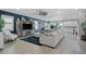 Open-concept living room boasts tile floors, modern lighting, and a comfortable sectional sofa at 13139 Stanthorne Ave, Orlando, FL 32832