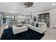 Spacious living room with a large sectional sofa, open to the kitchen and dining area at 13139 Stanthorne Ave, Orlando, FL 32832