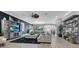 Spacious living room with gray decor, a ceiling fan, and tiled floors throughout the open floor plan at 13139 Stanthorne Ave, Orlando, FL 32832