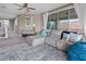 Cozy living room with a large sectional sofa, a ceiling fan, and natural light from sliding glass doors at 13139 Stanthorne Ave, Orlando, FL 32832