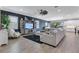 Bright and open living room with a large sectional, fireplace, and view into the kitchen at 13139 Stanthorne Ave, Orlando, FL 32832