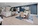 Open-concept living space with dark blue accent walls, tile flooring, and modern furnishings at 13139 Stanthorne Ave, Orlando, FL 32832